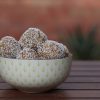 A green bowl on a wooden table.